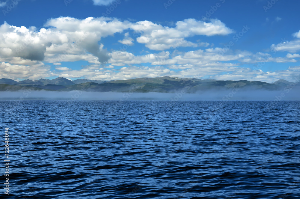 sea lanscape. blue sky, clouds over the surface of sea. mountain on horizon sea lanscape. blue sky, clouds over the surface of sea. mountain on horizon