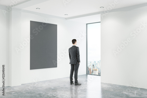 Businessman in office with blackboard
