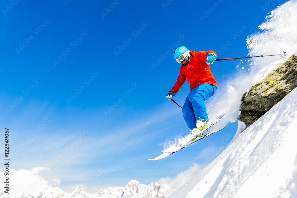 Man skiing in fresh powder snow in Italians Alps, captured jump