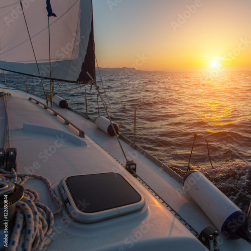 Beautiful sunset on a boat in the open sea. Luxury sailing yacht.