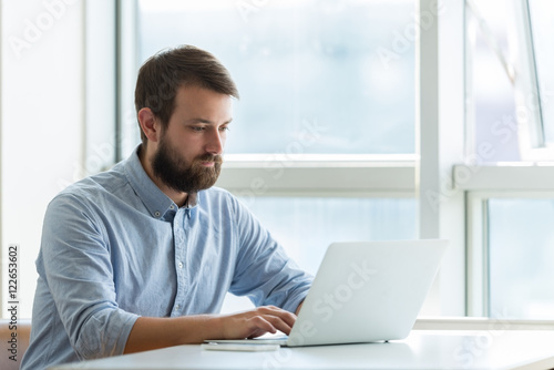 Businessman typing on laptop