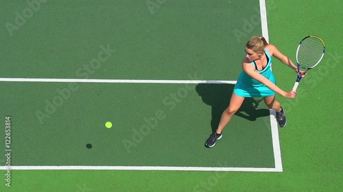Young female tennis player runs to backhand return.