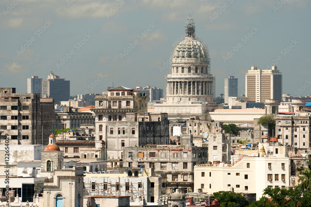 Reconstructed Capitol, ancient ragged houses and cityscape of Havana at summer sunny day