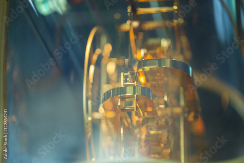 The mechanism of the clock, antique gold stored in the cabinet.