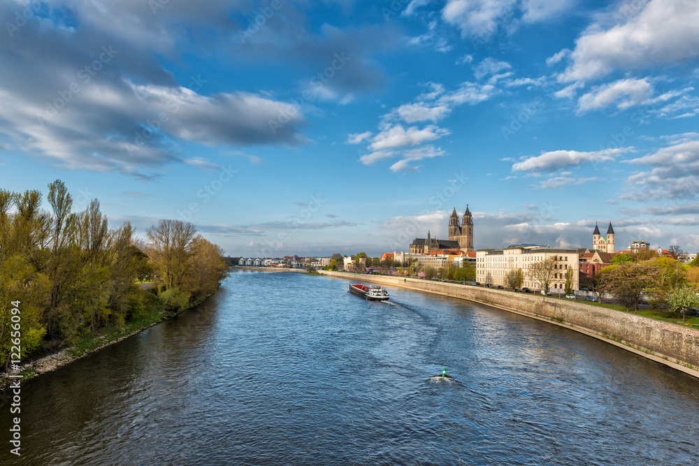 Magdeburg - wide view on the cathedral and river Elbe, beautiful landscape with blue sky and clouds, Saxony, Germany