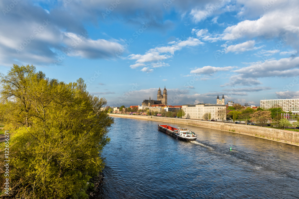 View of Magdeburg with cathedral and river Elbe, bright daylight landscape with blue sky and clouds, Saxony, Germany View of Magdeburg with cathedral and river Elbe, bright daylight landscape with blue sky and clouds, Saxony, Germany