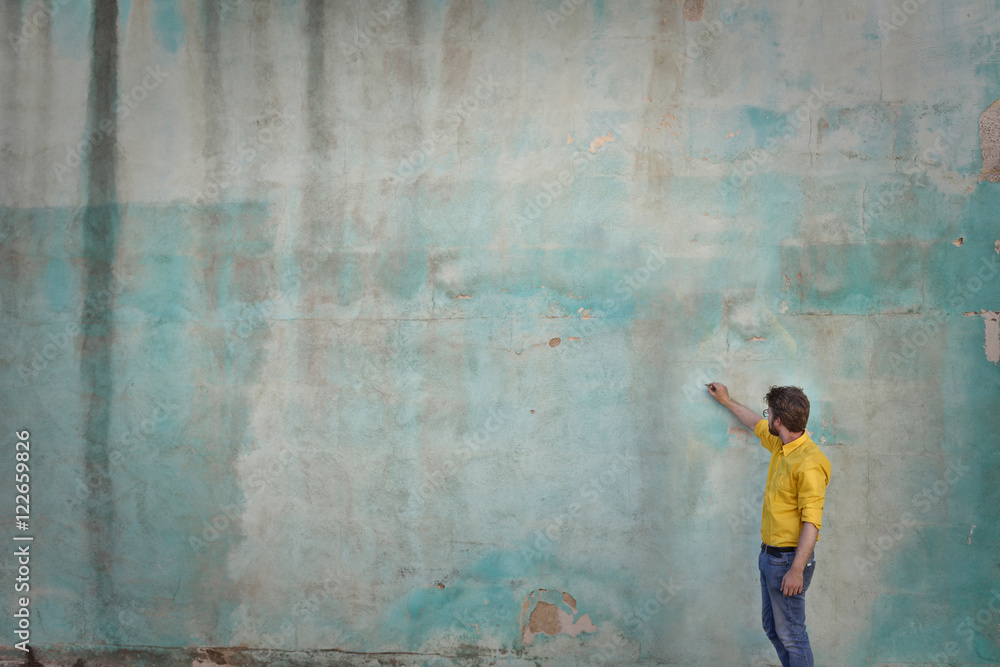 Man writing on a blank wall Man writing on a blank wall