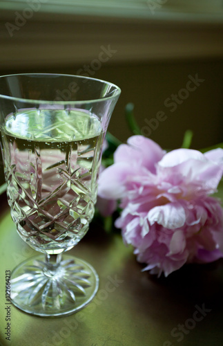 Champagne flute with pink flowers on gold tray