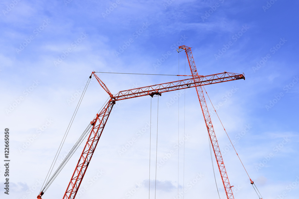 The red arm of the construction crane with the blue sky. The red arm of the construction crane with the blue sky.