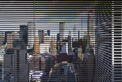 View through window blinds towards city