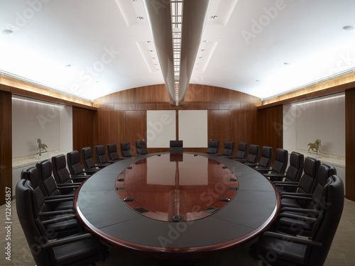 Oval boardroom table with empty chairs