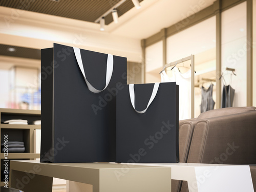 Two black shopping bags in bright boutique. 3d rendering