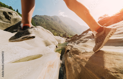 Hiker walking through the rocky land. Focus on the background, close up