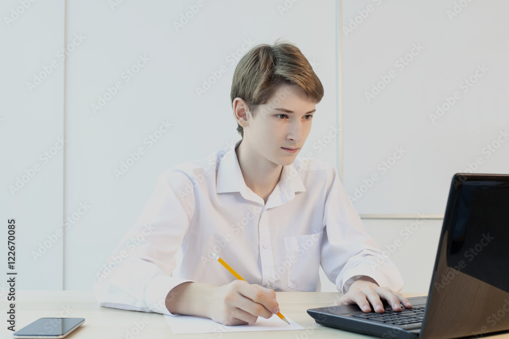 cute caucasian teenage school student working at a laptop cute caucasian teenage school student working at a laptop