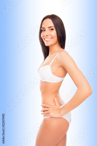 Photos Side view photo of cheerful smiling young woman in white lingeri