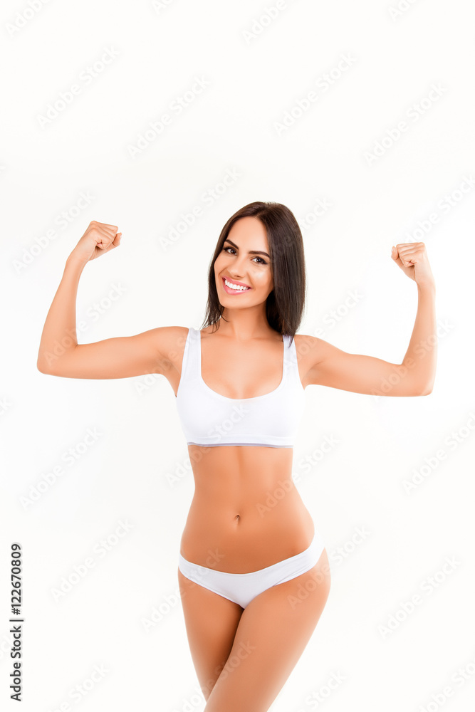 Happy woman in lingerie showing her muscular hands Happy woman in lingerie showing her muscular hands