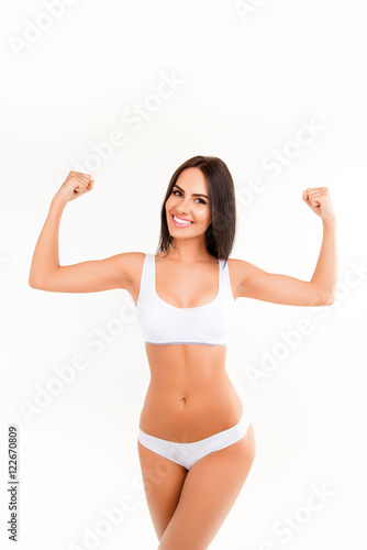 Happy woman in lingerie showing her muscular hands