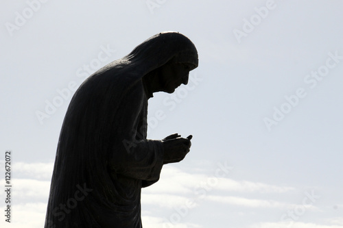 Silhouete of a Statue of Mother Teresa in City of Struga, Ohrid Lake, Macedonia. photo