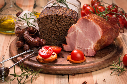 Antipasto catering platter with salami and meat on a wooden background photo