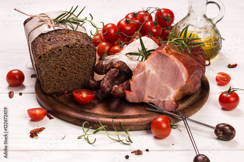 Antipasto catering platter with salami and meat on a wooden background photo