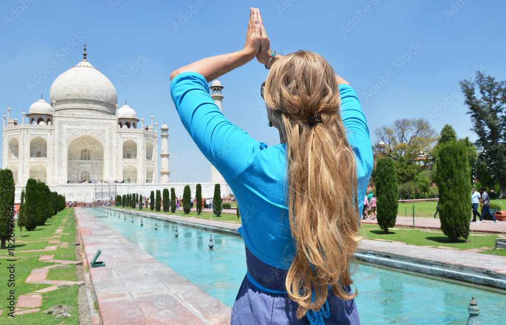 Young woman meditating at Taj Mahal. Agra, India