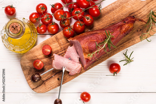 Antipasto catering platter with salami and meat on a wooden background photo