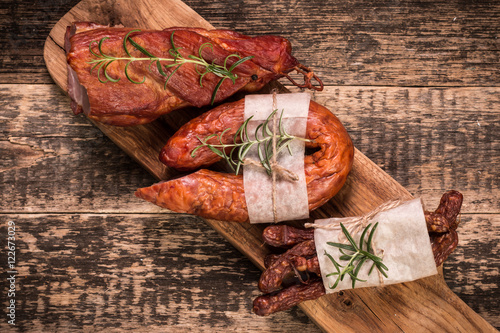 Antipasto catering platter with salami and meat on a wooden background photo