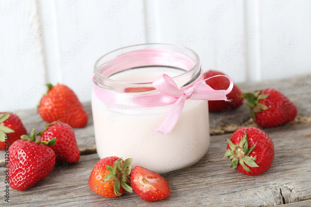 Strawberry yogurt in glass on wooden table Strawberry yogurt in glass on wooden table