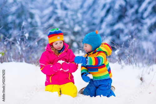 Children playing in snowy winter park