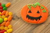 Smiling pumpkin cookie with many colorful candies