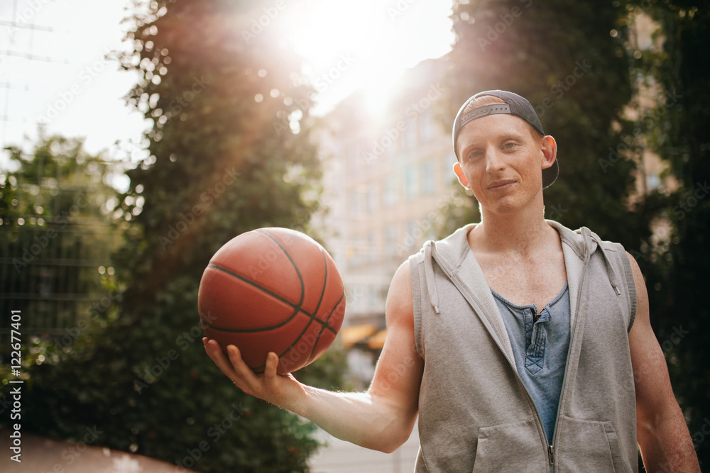 Teenage streetball player with a ball in hand Teenage streetball player with a ball in hand