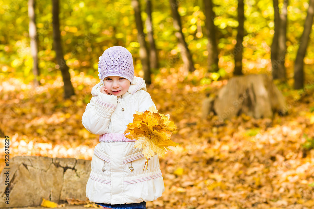 Little baby girl with autumn leaves in the park Little baby girl with autumn leaves in the park