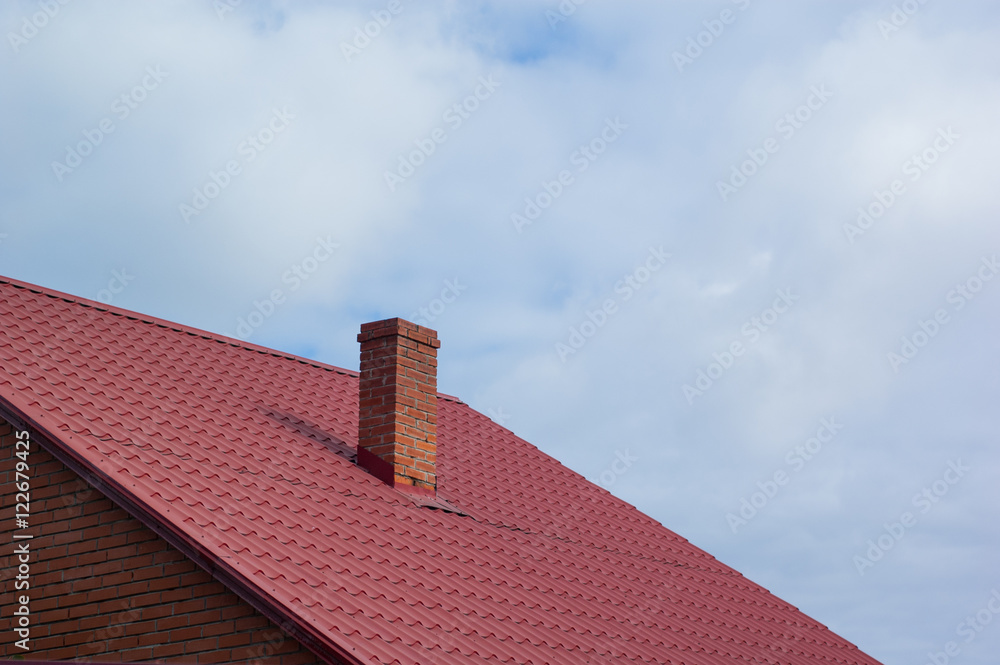 Part of the red-tiled roof of one of the private houses.