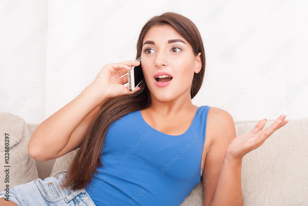 girl using her smartphone on the couch at home girl using her smartphone on the couch at home
