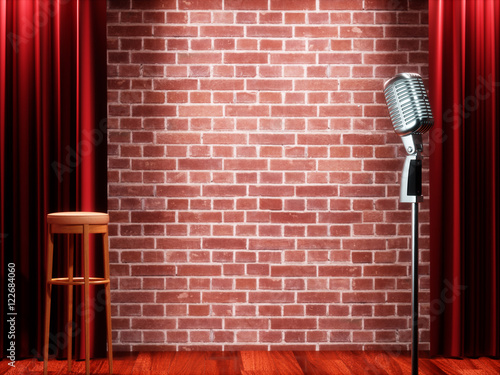 Tableau sur toile Vintage metal microphone against red curtain on empty theatre stage