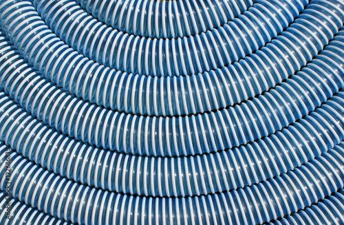 Blue and white corrugated plastic hose as background