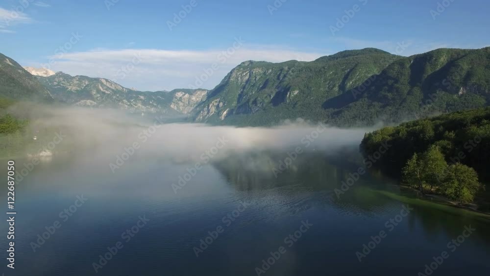AERIAL VIEW: flight over Bohinj lake, camera moving forvards over clouds .Triglav National Park AERIAL VIEW: flight over Bohinj lake, camera moving forvards over clouds .Triglav National Park
