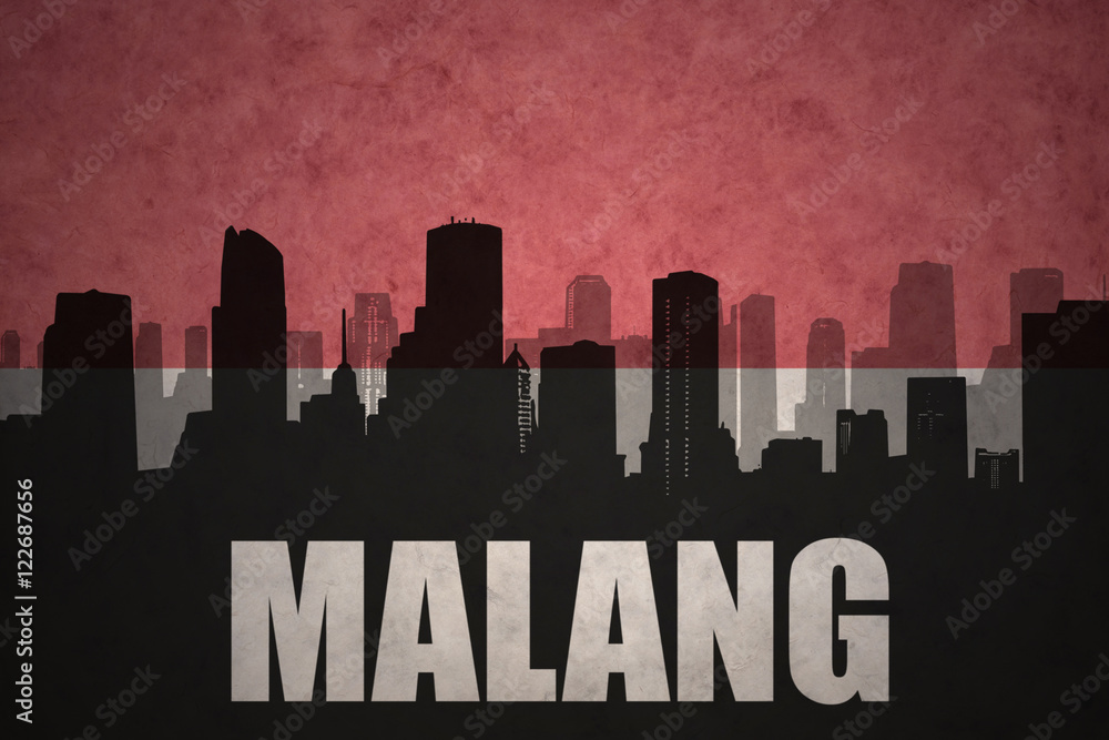 abstract silhouette of the city with text Malang at the vintage indonesian flag background