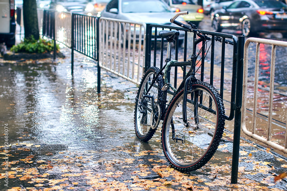 Bicycle parked at the street on a rainy day Bicycle parked at the street on a rainy day