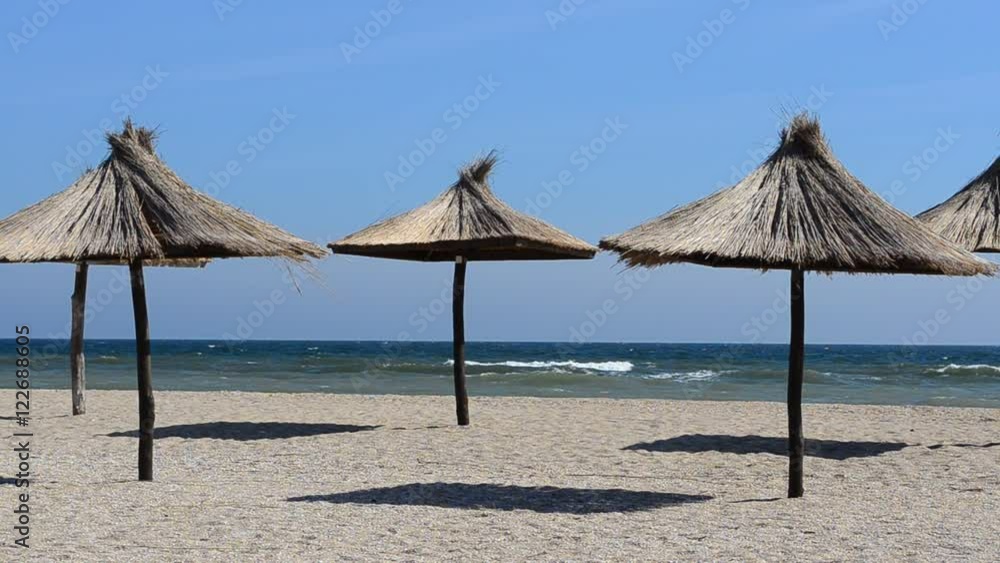 Straw umbrellas on the beach. Straw umbrellas on the beach.