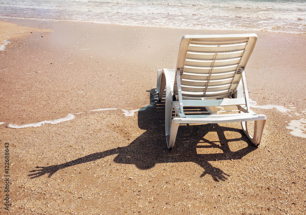 Humorous scene: cheerful invisible somebody with shadow on the sand Humorous scene: cheerful invisible somebody with shadow on the sand