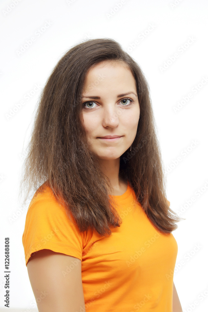 Close-up portrait of smiling beautiful girl. Over white background. Smiling girl in an orange T-shirt. Age defying skin care anti aging flawless spa treatment beautiful woman smiles Close-up portrait of smiling beautiful girl. Over white background. Smiling girl in an orange T-shirt. Age defying skin care anti aging flawless spa treatment beautiful woman smiles