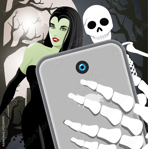 Halloween selfie with vampiress and skeleton in a graveyard.