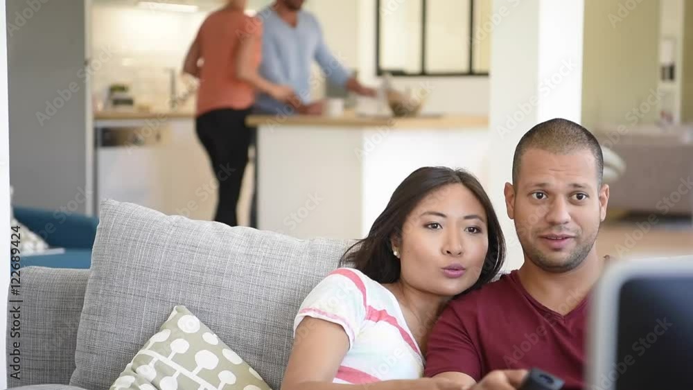 Couple at home in sofa watching movie on tv Couple at home in sofa watching movie on tv