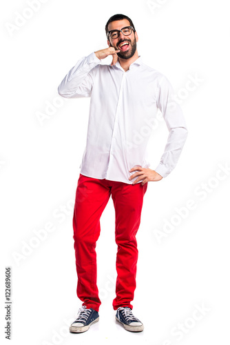 Handsome man with glasses making phone gesture