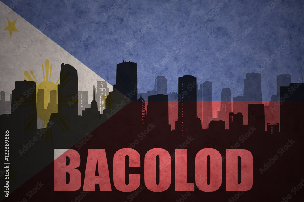 abstract silhouette of the city with text Bacolod at the vintage philippines flag background
