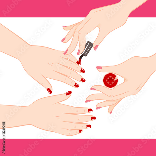 Two female hands getting manicure service of red nail polish
