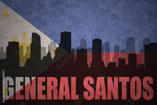 abstract silhouette of the city with text General Santos at the vintage philippines flag background