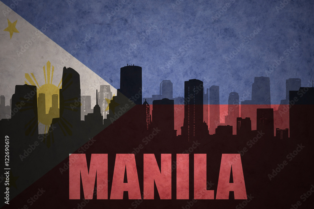 abstract silhouette of the city with text manila at the vintage philippines flag background