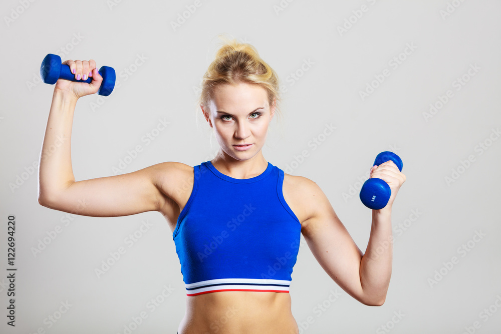 Fit woman lifting dumbbells weights Fit woman lifting dumbbells weights